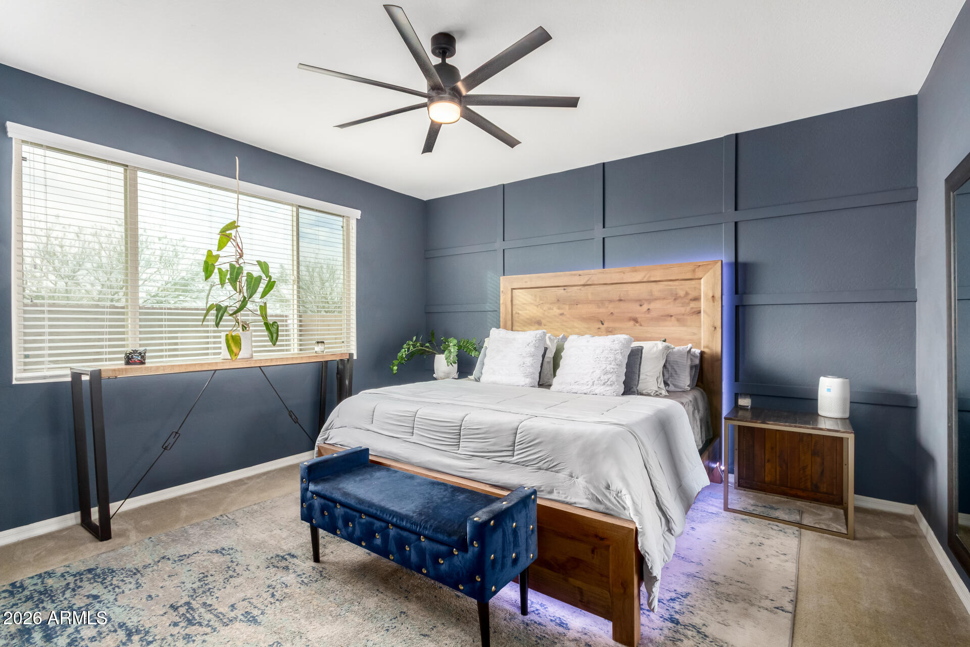 21057 West Almeria Road Buckeye, AZ 85396 - Photo 12 of 49 a bedroom with a bed mirror and window