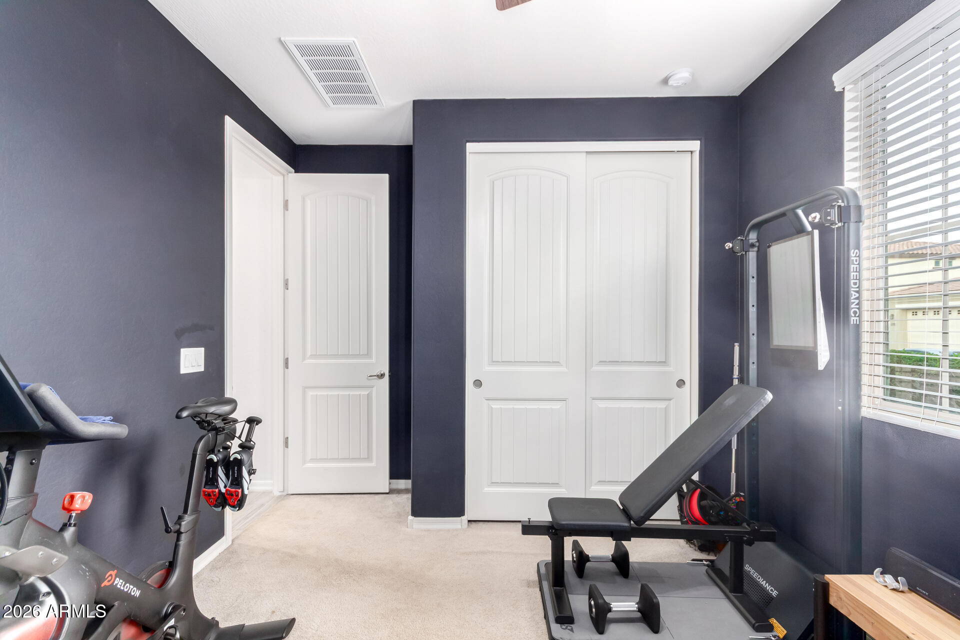 21057 West Almeria Road Buckeye, AZ 85396 - Photo 19 of 49 a view of a room with gym equipment