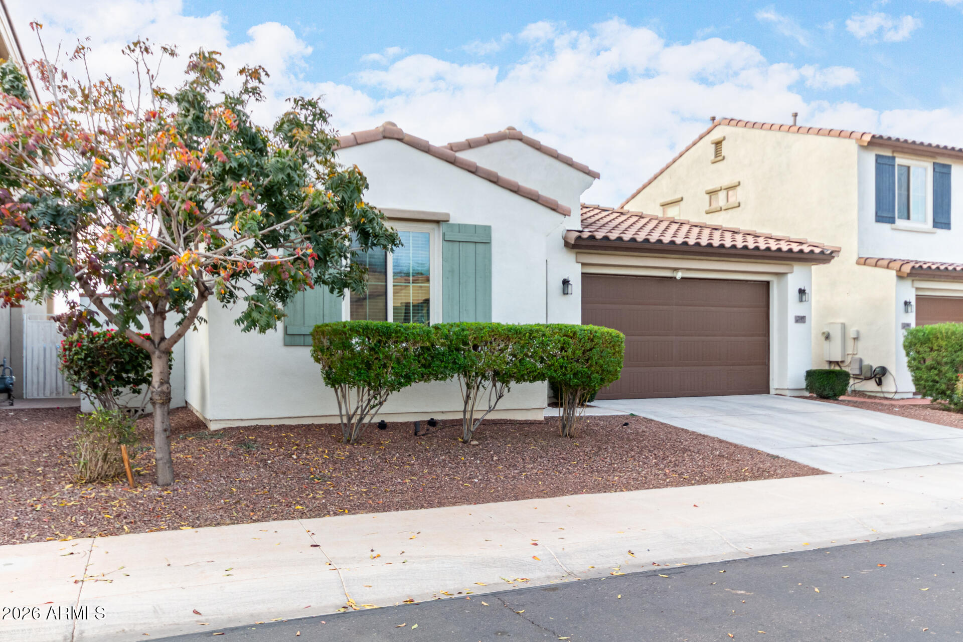 21057 West Almeria Road Buckeye, AZ 85396 - Photo 2 of 49 a front view of a house with garden