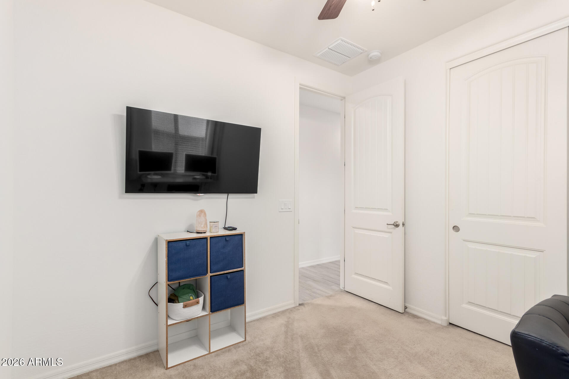 21057 West Almeria Road Buckeye, AZ 85396 - Photo 21 of 49 a living room with furniture and a flat screen tv