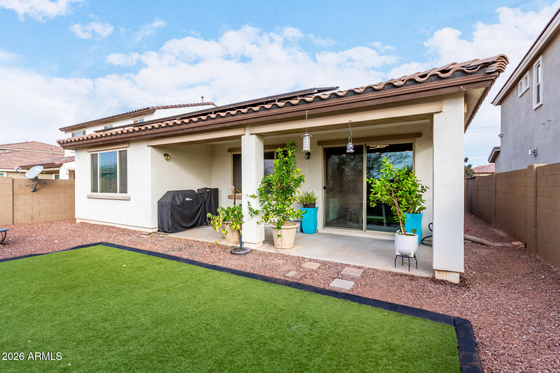 21057 West Almeria Road Buckeye, AZ 85396 - Photo 26 of 49 a front view of a house with a garden and plants