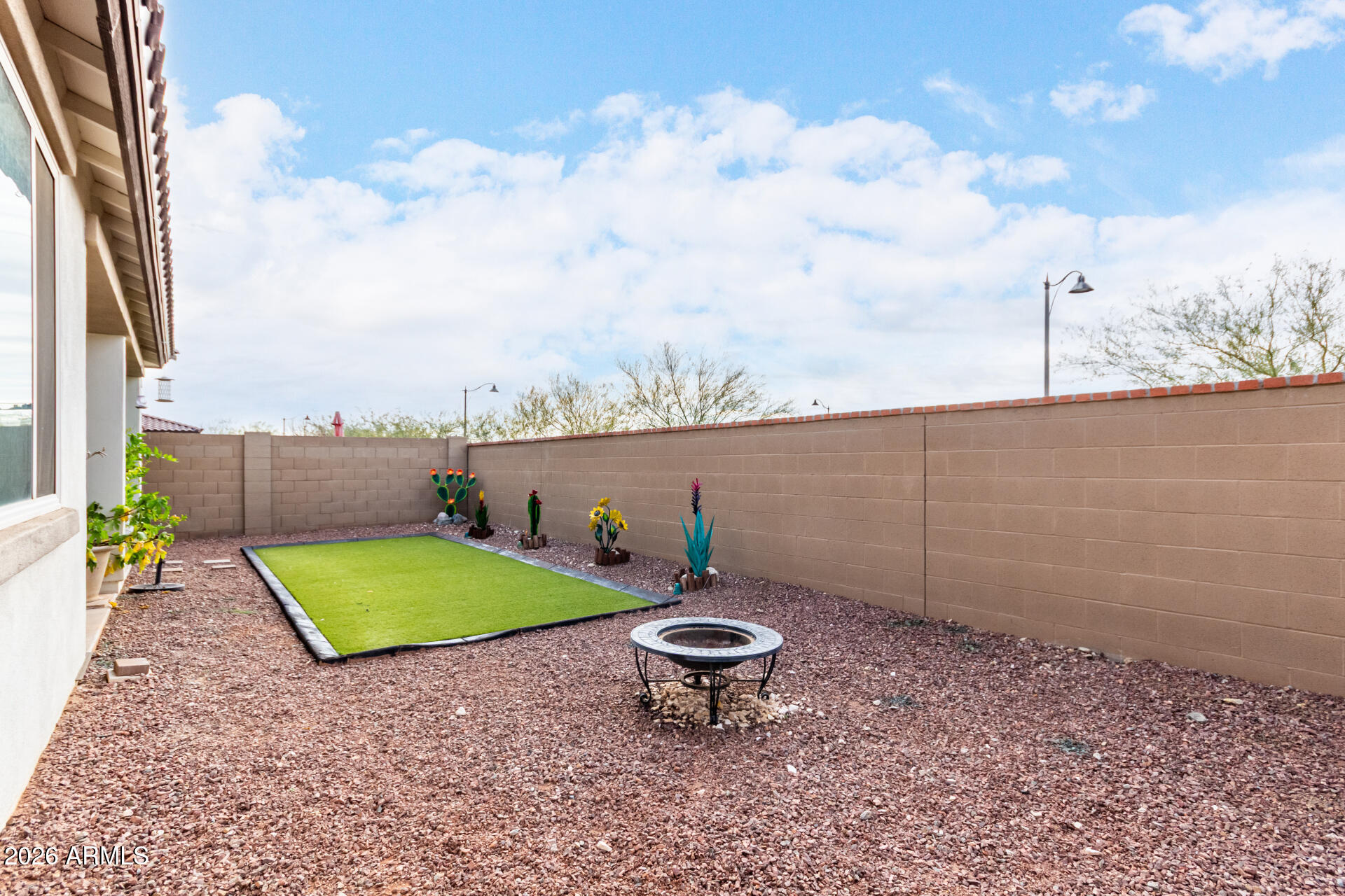 21057 West Almeria Road Buckeye, AZ 85396 - Photo 28 of 49 a view of a backyard with plants and lake view