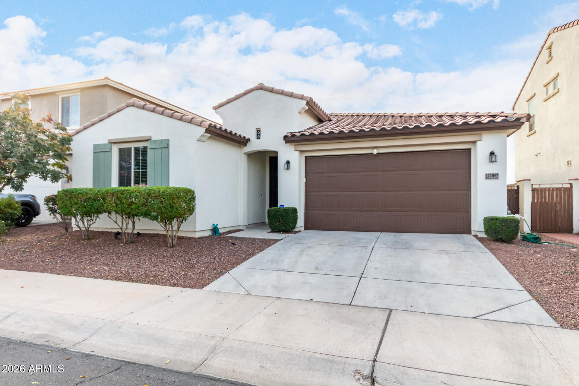 21057 West Almeria Road Buckeye, AZ 85396 - Photo 3 of 49 a front view of a house with a yard and garage