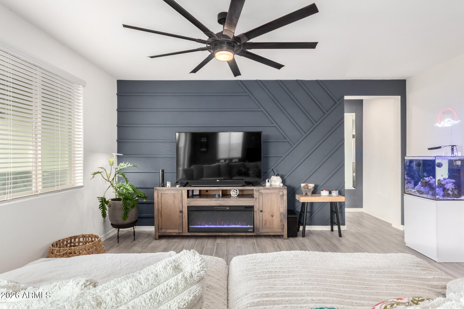 21057 West Almeria Road Buckeye, AZ 85396 - Photo 6 of 49 a living room with furniture and a flat screen tv