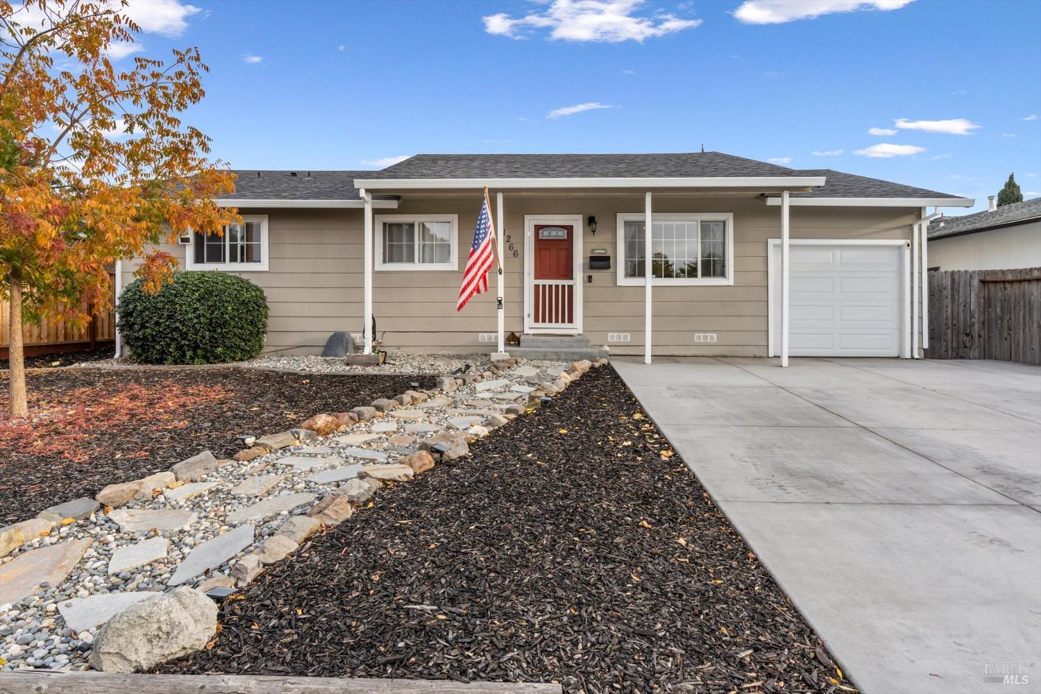 a front view of a house with a garden