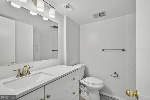 a bathroom with a sink toilet a mirror and shower