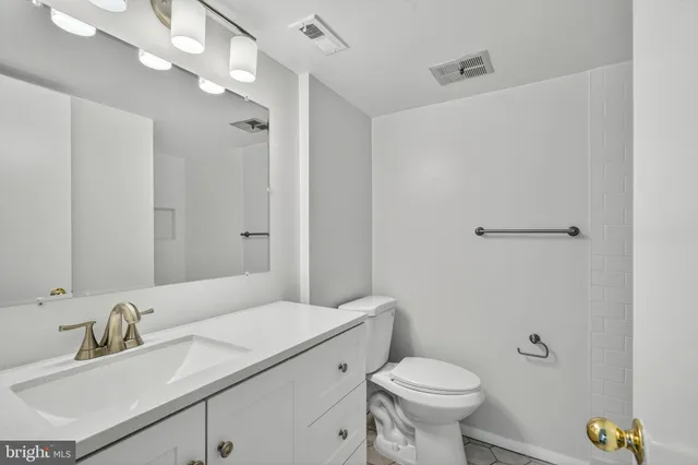 a bathroom with a sink toilet a mirror and shower