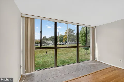 a view of an empty room with large windows