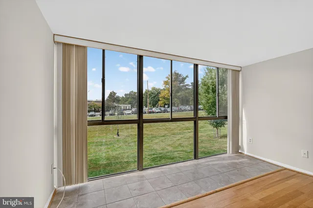 a view of an empty room with large windows