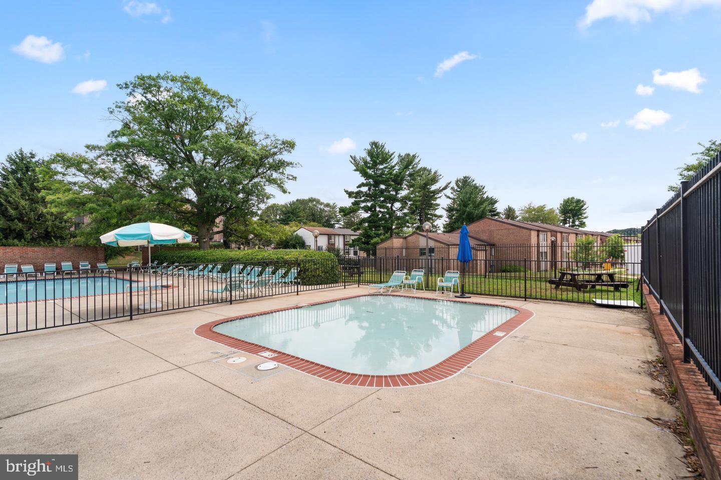 18910 Smoothstone Way, Unit 4 Montgomery Village, MD 20886 - Photo 27 of 30 a view of a swimming pool with a patio