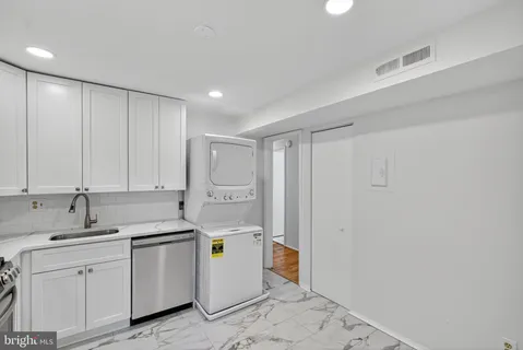 a view of a storage & utility room with a sink