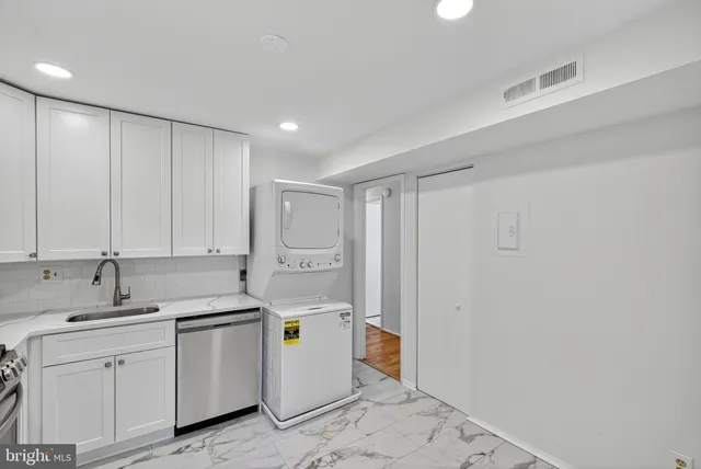 a view of a storage & utility room with a sink