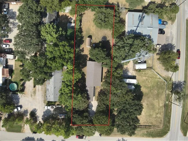 an aerial view of a house with a yard and lake view