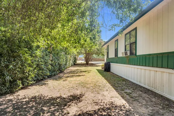 a view of a yard with wooden fence