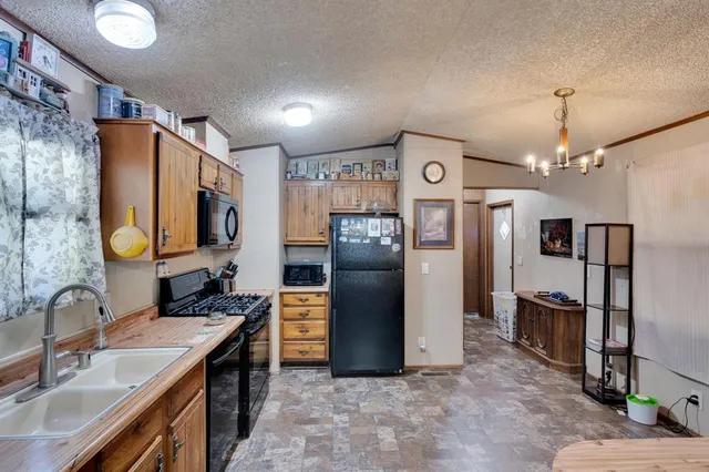 a kitchen with refrigerator a sink and a stove