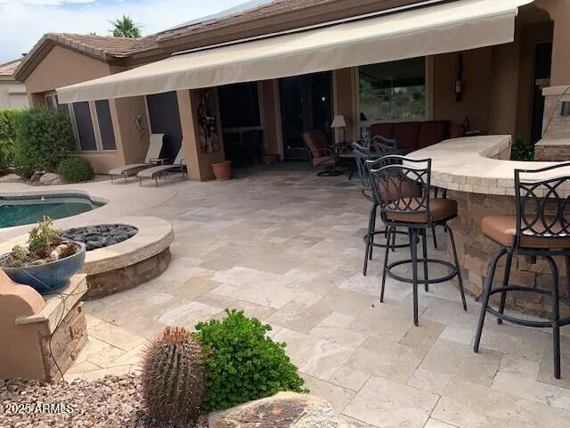a view of a patio with table and chairs with wooden floor and fence