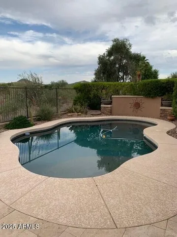a view of swimming pool with a patio