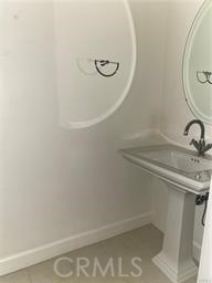 14412 Killion Street Sherman Oaks, CA 91401 - Photo 11 of 21 a bathroom with a sink and mirror