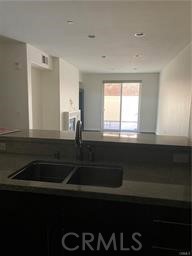 14412 Killion Street Sherman Oaks, CA 91401 - Photo 3 of 21 a kitchen with a sink a stove and cabinets