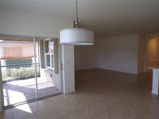 a living room with a table and a large window