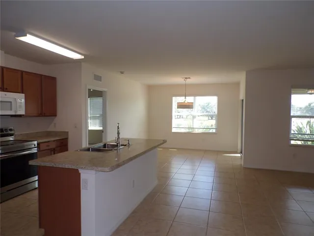 a kitchen with a sink cabinets and window