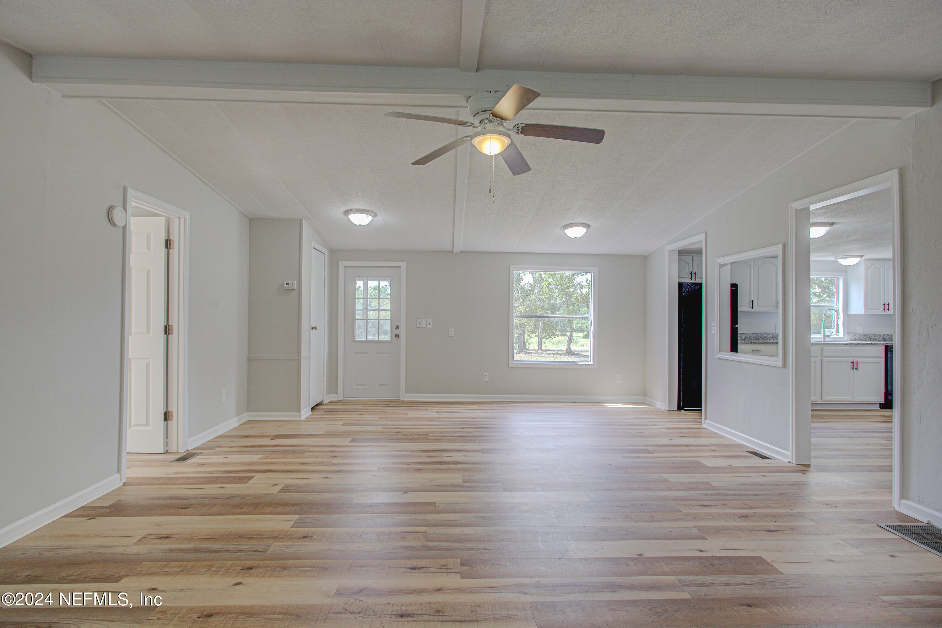 7677 Oak Forest Road Keystone Heights, FL 32656 - Photo 12 of 54 a view of an empty room with window and wooden floor