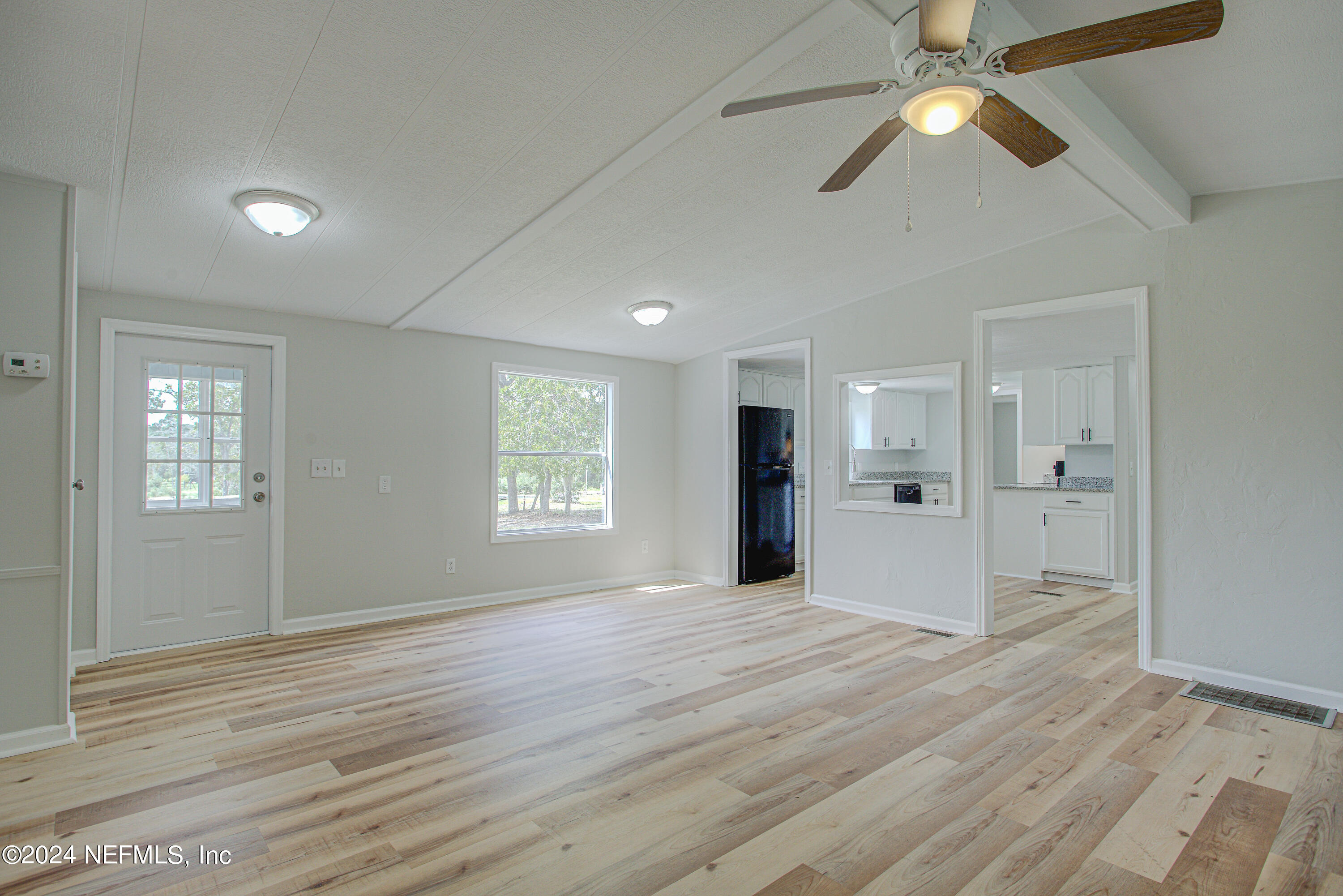 7677 Oak Forest Road Keystone Heights, FL 32656 - Photo 13 of 54 a view of an empty room with a window and wooden floor