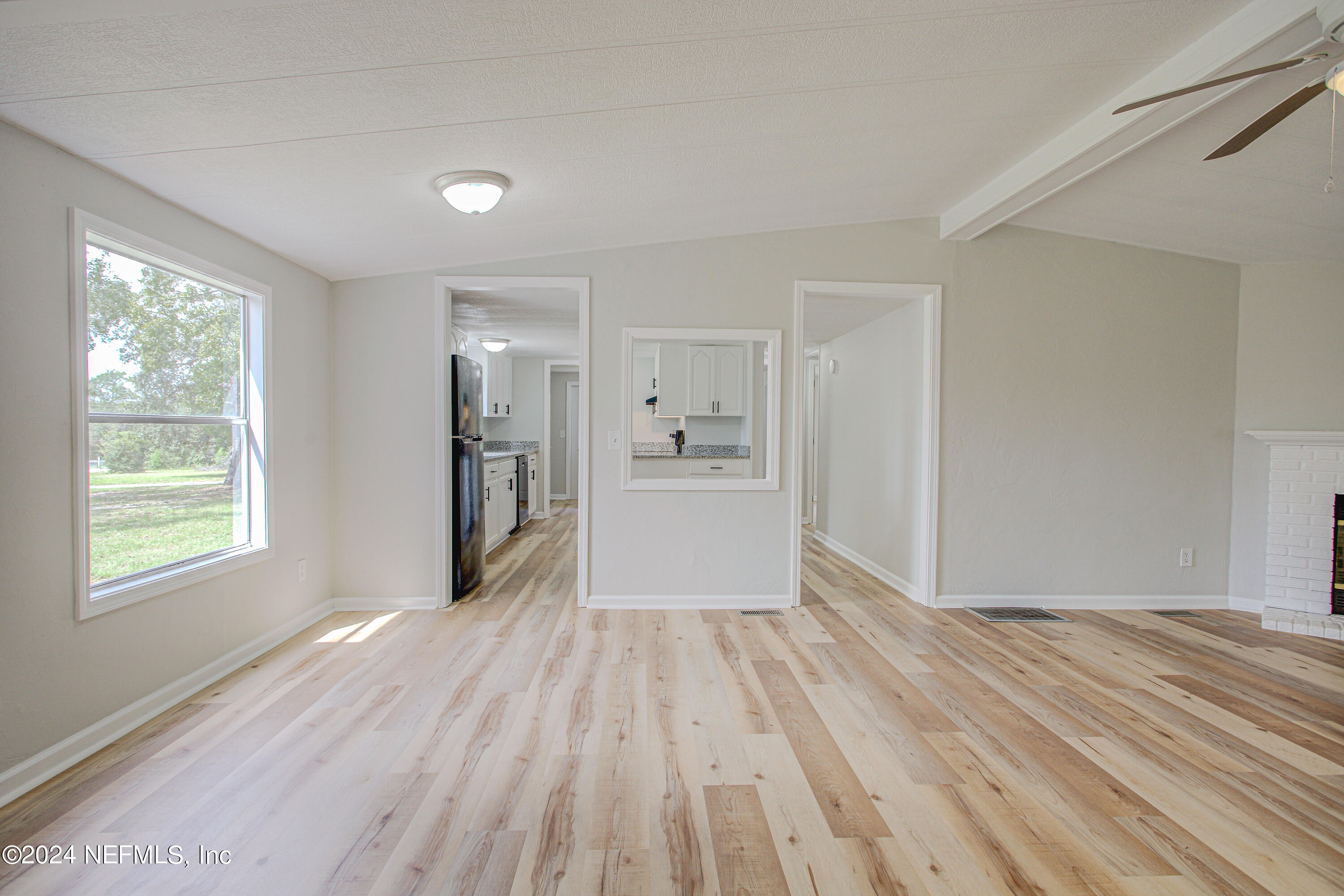 7677 Oak Forest Road Keystone Heights, FL 32656 - Photo 14 of 54 a view of a big room with wooden floor and windows