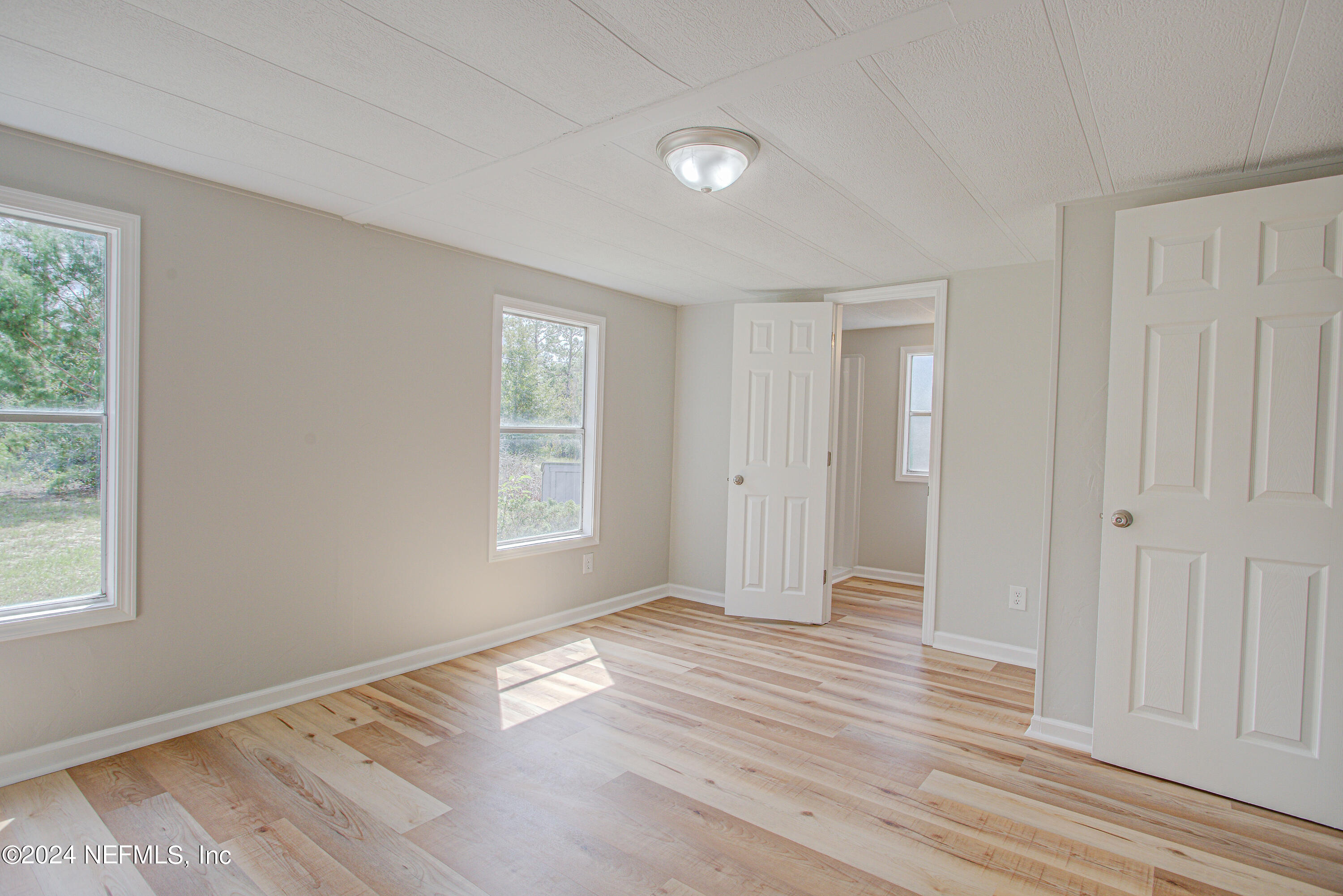 7677 Oak Forest Road Keystone Heights, FL 32656 - Photo 31 of 54 a view of empty room with wooden floor and fan