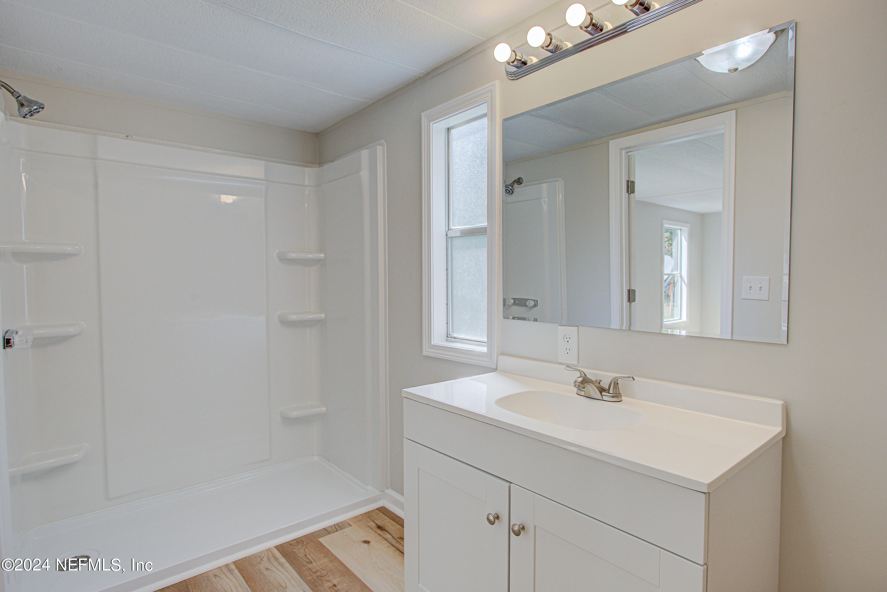 7677 Oak Forest Road Keystone Heights, FL 32656 - Photo 33 of 54 a bathroom with a sink a shower and a mirror