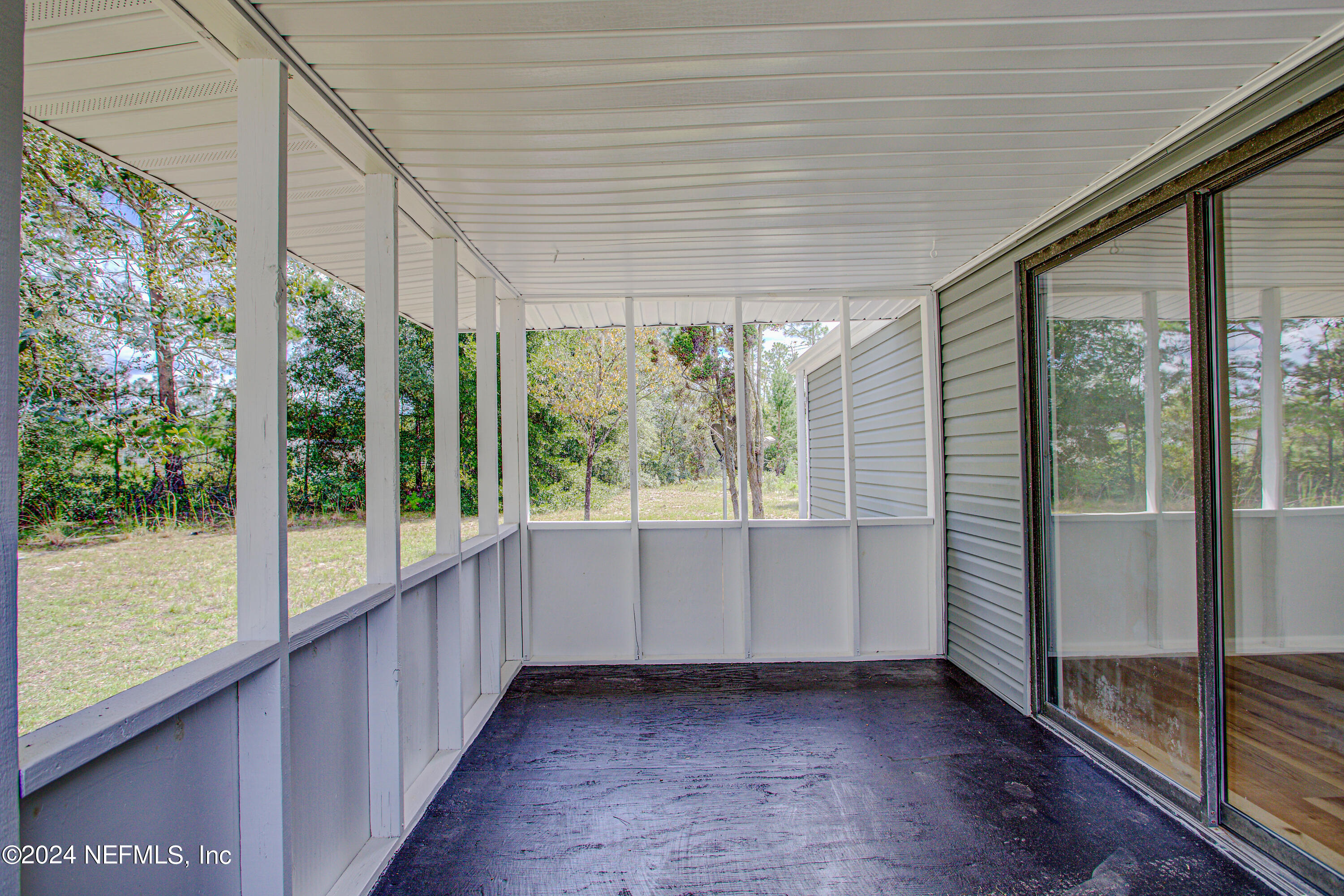 7677 Oak Forest Road Keystone Heights, FL 32656 - Photo 36 of 54 wooden floor in an empty room with a window