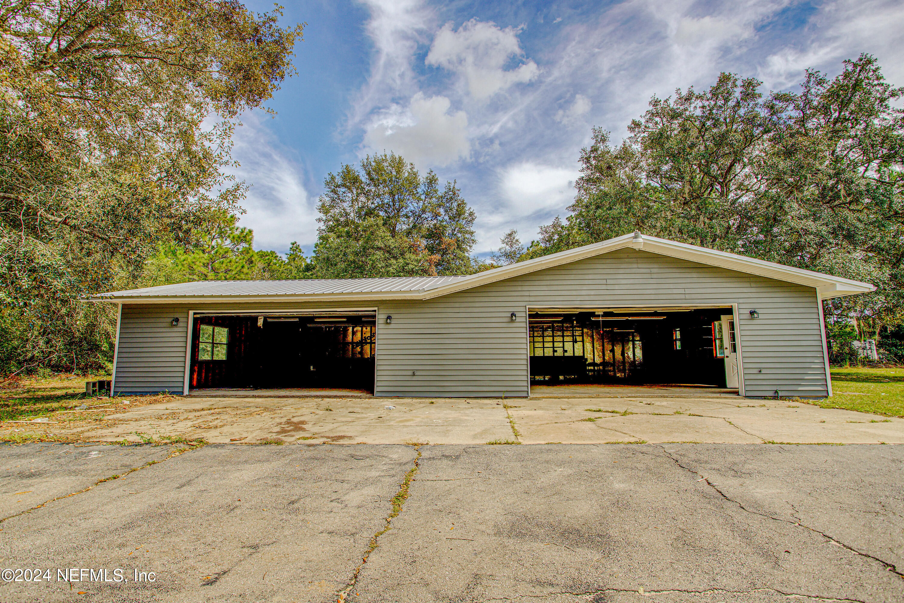 7677 Oak Forest Road Keystone Heights, FL 32656 - Photo 4 of 54 a house with trees in the background