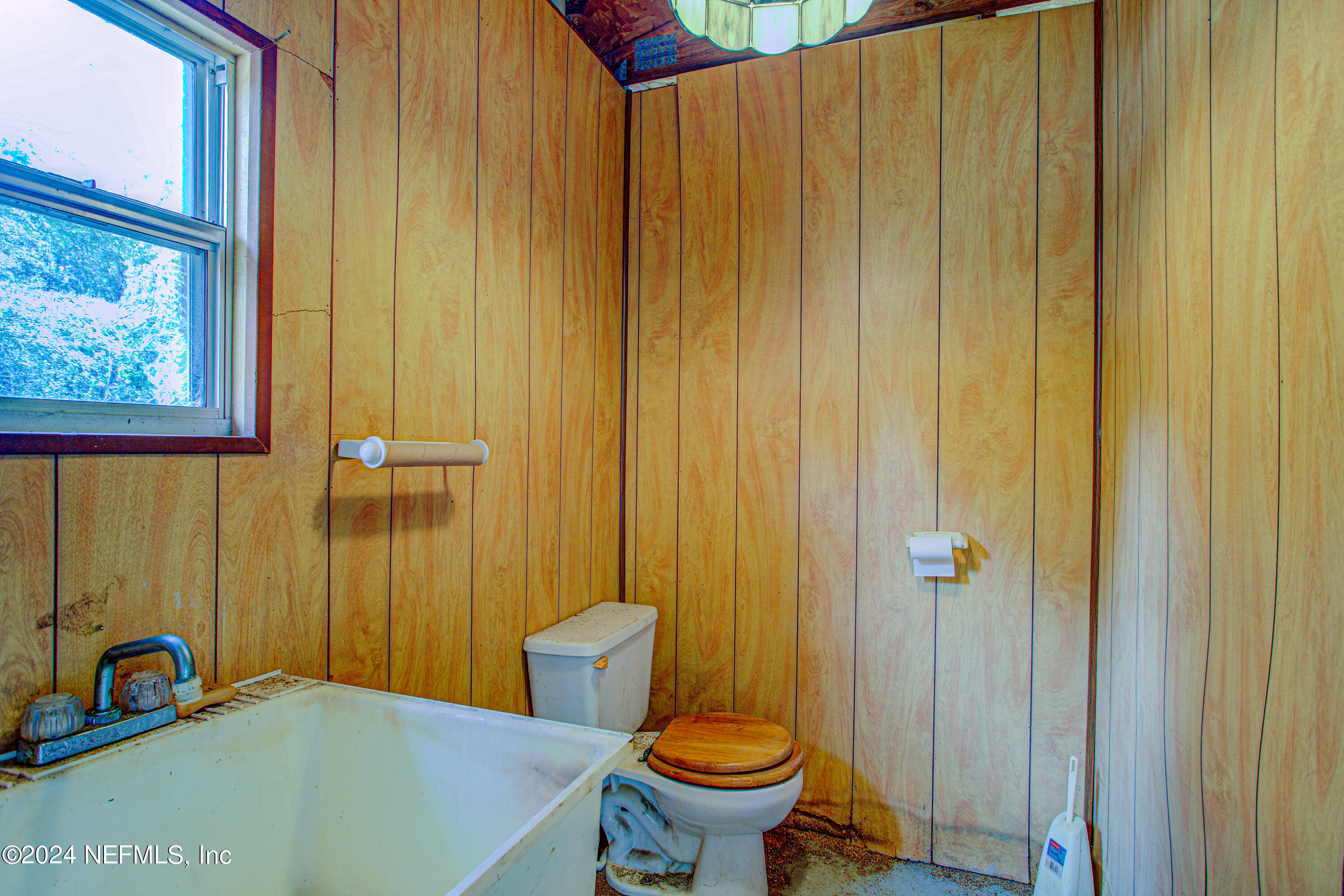 7677 Oak Forest Road Keystone Heights, FL 32656 - Photo 45 of 54 a bathroom with a sink a toilet and shower curtain