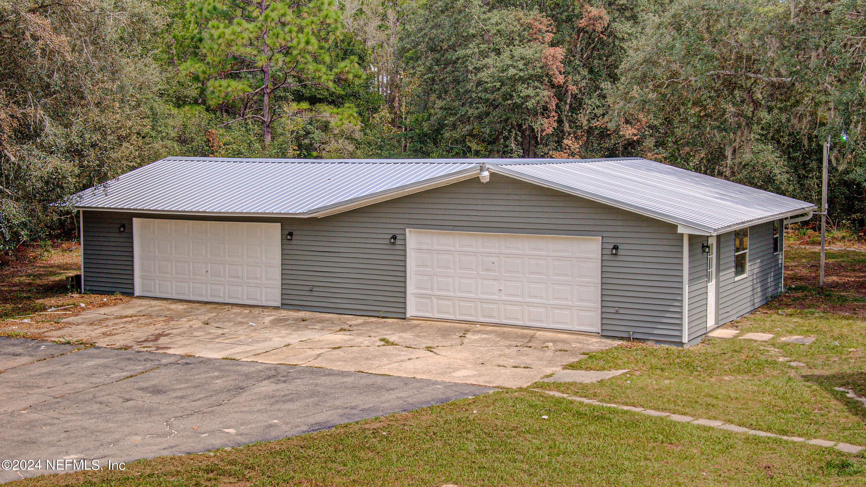 7677 Oak Forest Road Keystone Heights, FL 32656 - Photo 5 of 54 a front view of a house with a garage