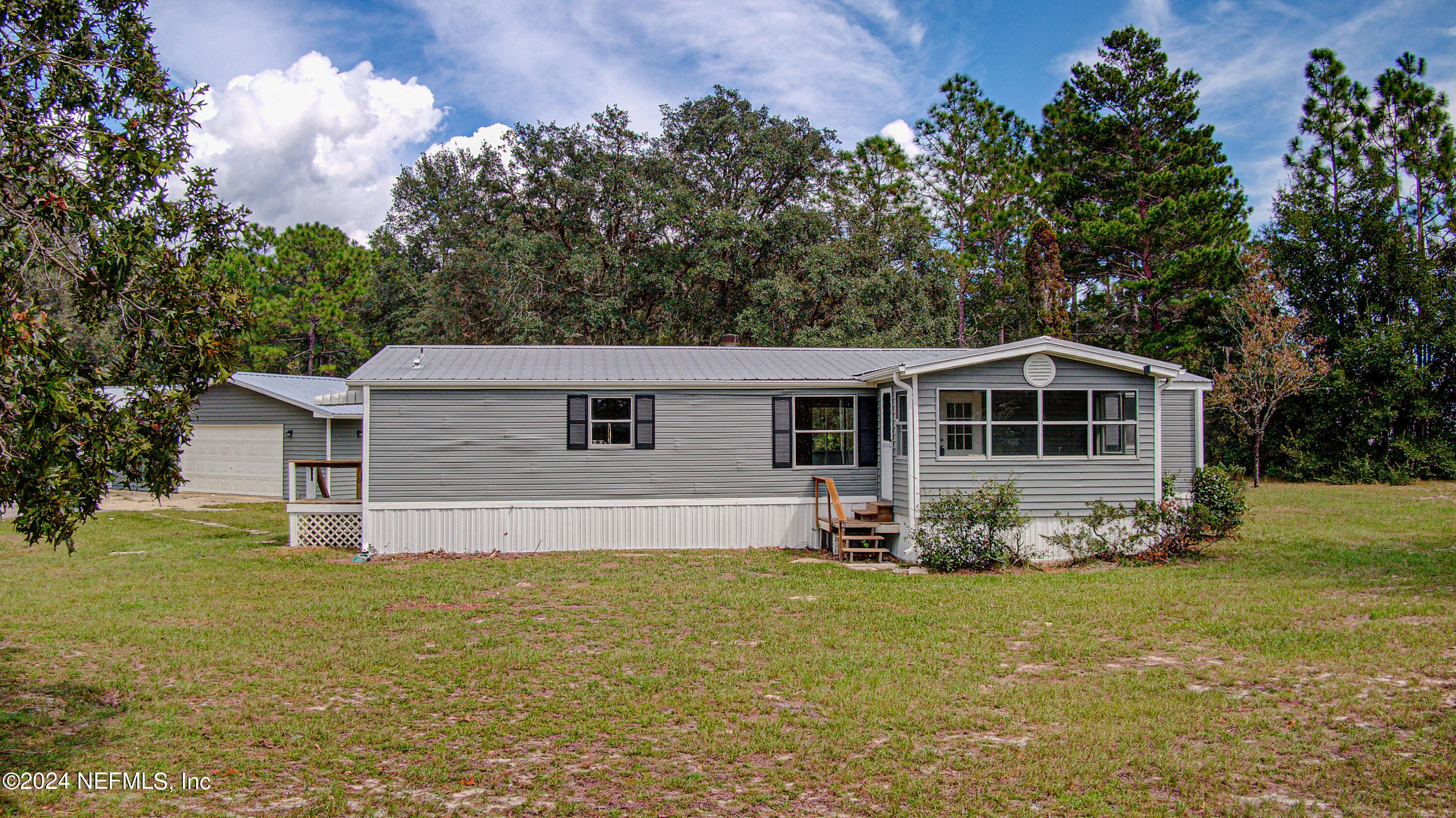 7677 Oak Forest Road Keystone Heights, FL 32656 - Photo 51 of 54 a front view of a house with garden