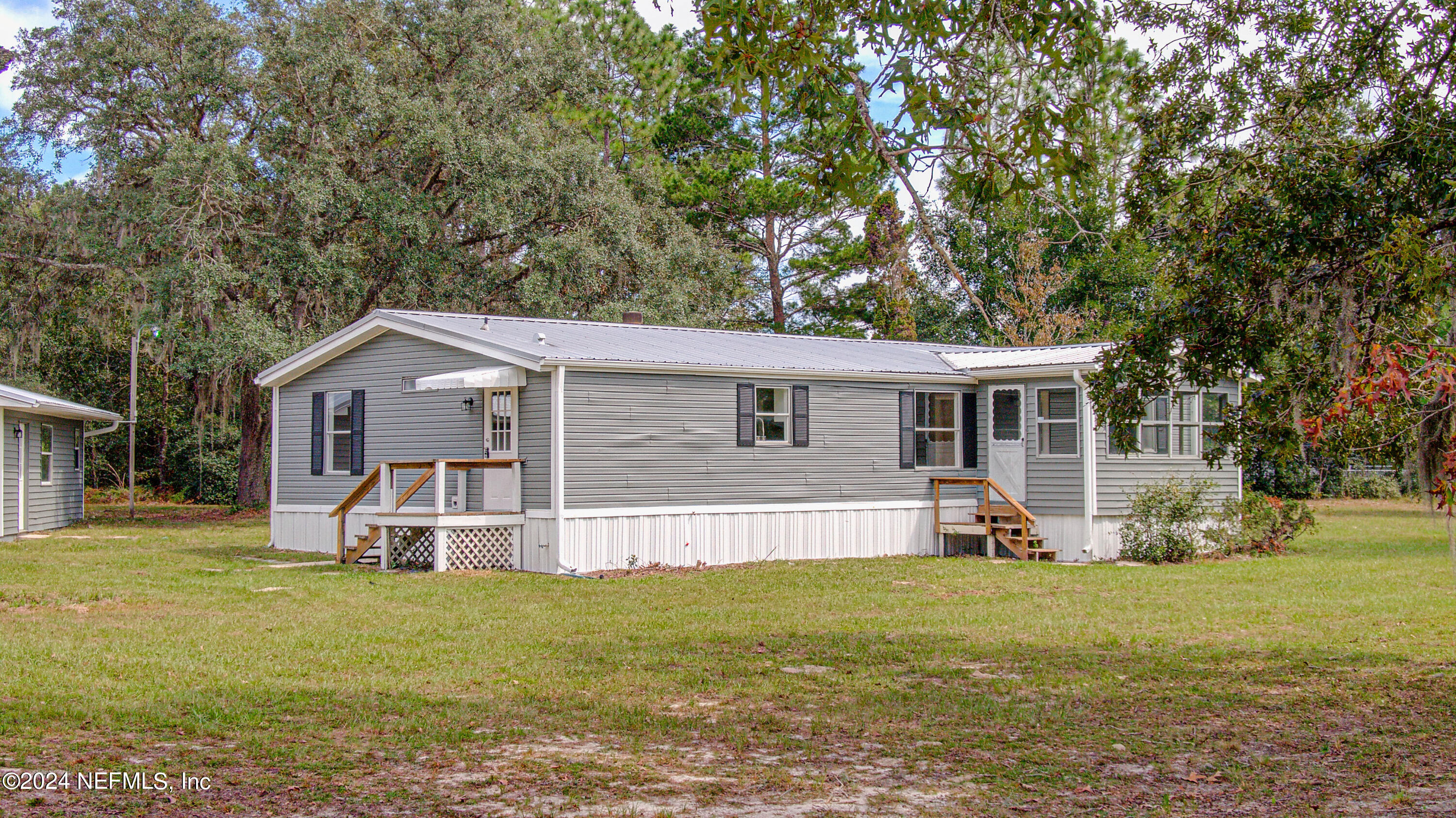 7677 Oak Forest Road Keystone Heights, FL 32656 - Photo 52 of 54 a front view of house with yard and seating area