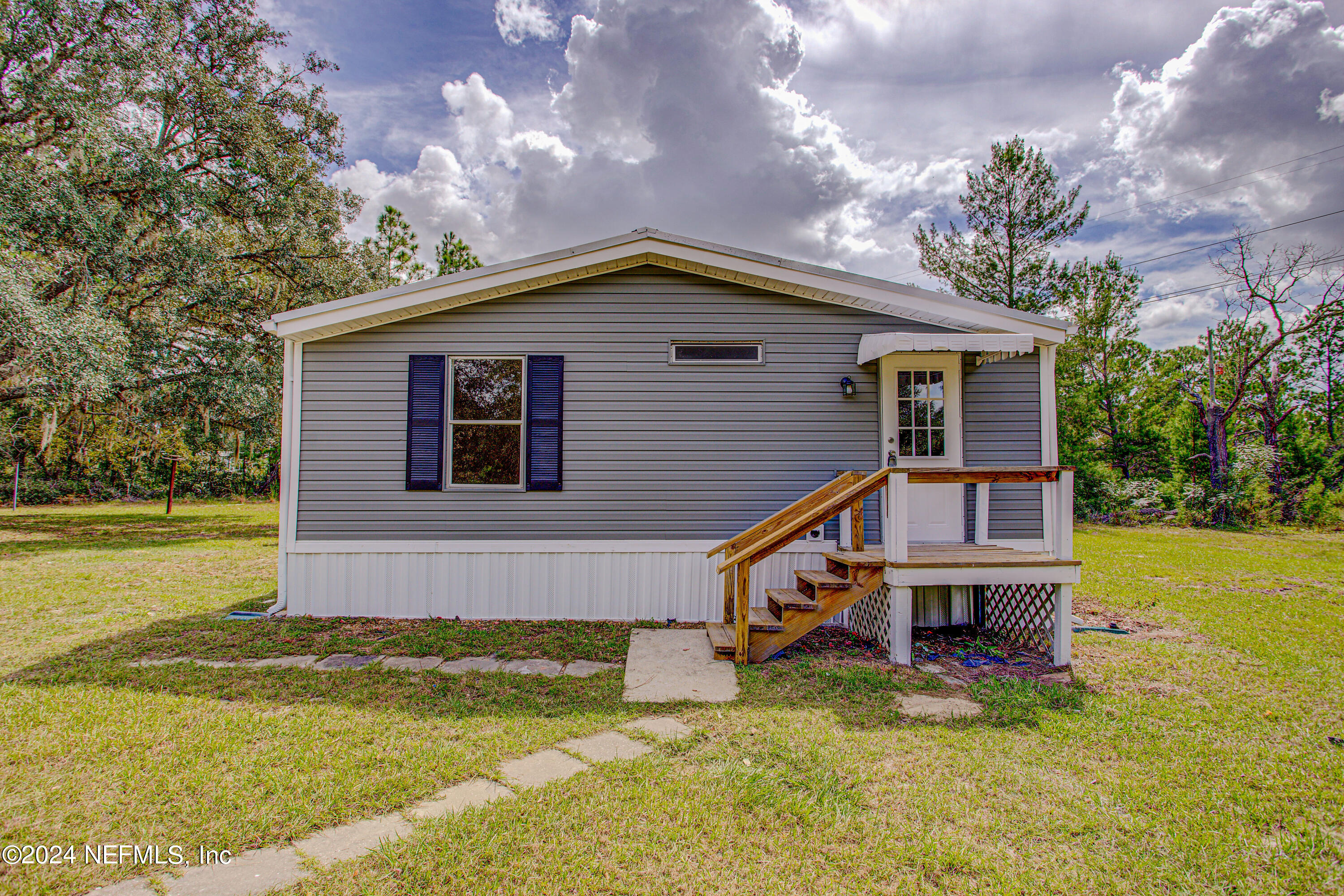 7677 Oak Forest Road Keystone Heights, FL 32656 - Photo 9 of 54 a house view with a swimming pool and wooden fence