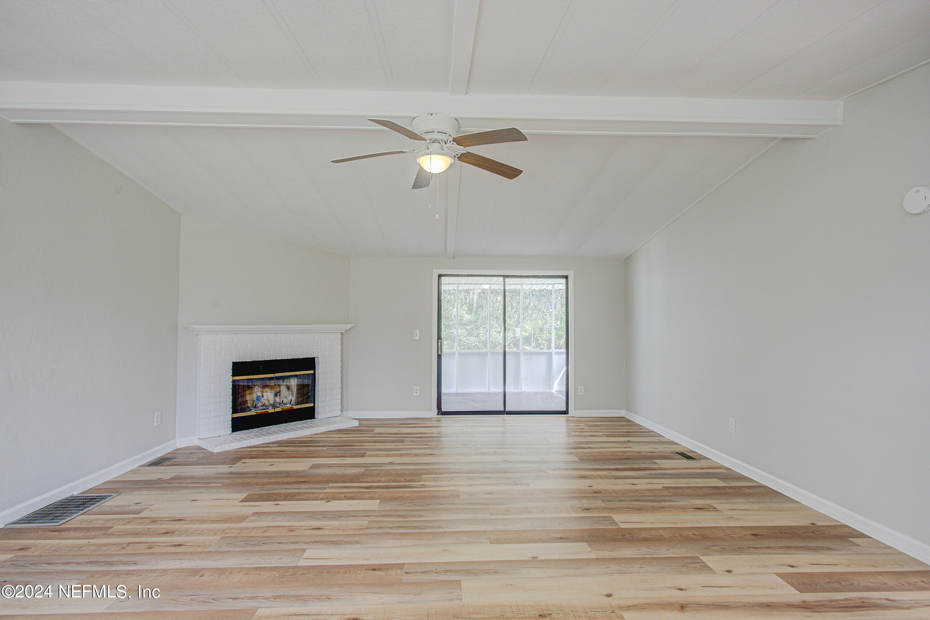 7677 Oak Forest Road Keystone Heights, FL 32656 - Photo 10 of 54 a view of empty room with wooden floor and fan
