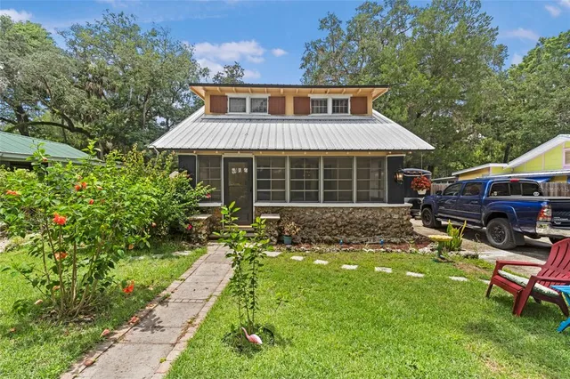 a front view of a house with a yard table and chairs