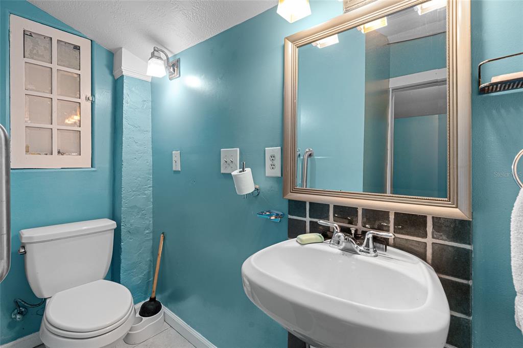 11 62nd Street Yankeetown, FL 34498 - Photo 30 of 33 a bathroom with a sink a toilet and mirror