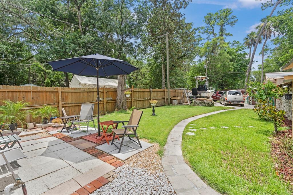 11 62nd Street Yankeetown, FL 34498 - Photo 7 of 33 an outdoor space with furniture and umbrella
