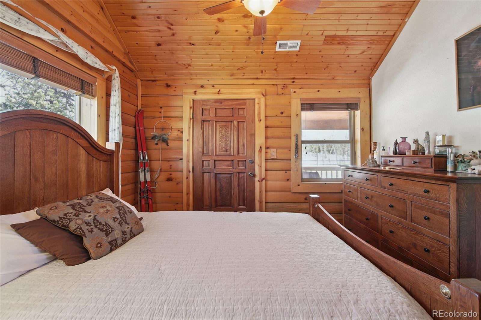 499 Clark Road Bailey, CO 80421 - Photo 11 of 27 a bedroom with a bed and a dresser