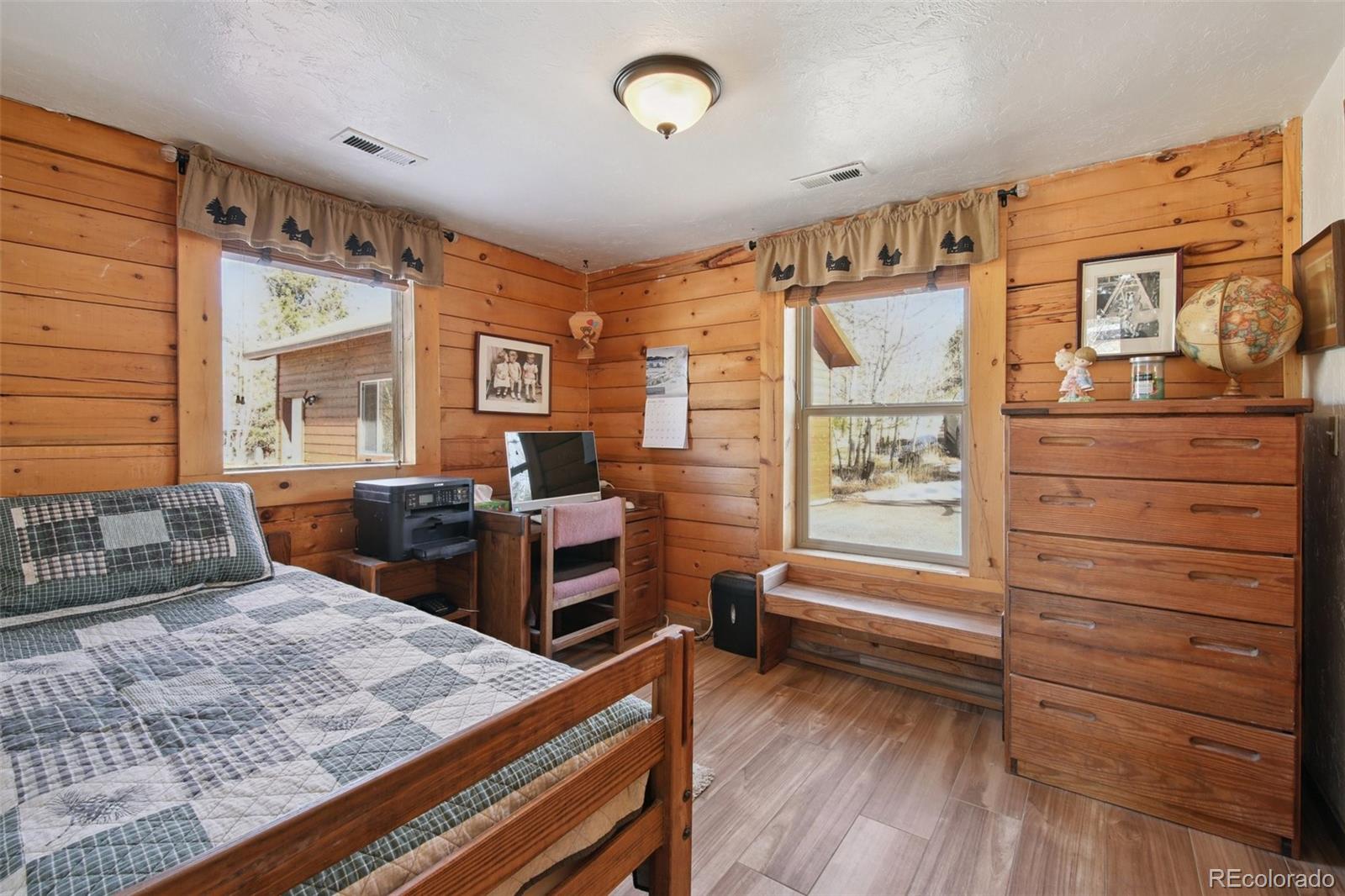 499 Clark Road Bailey, CO 80421 - Photo 12 of 27 a bedroom with a bed and wooden floor