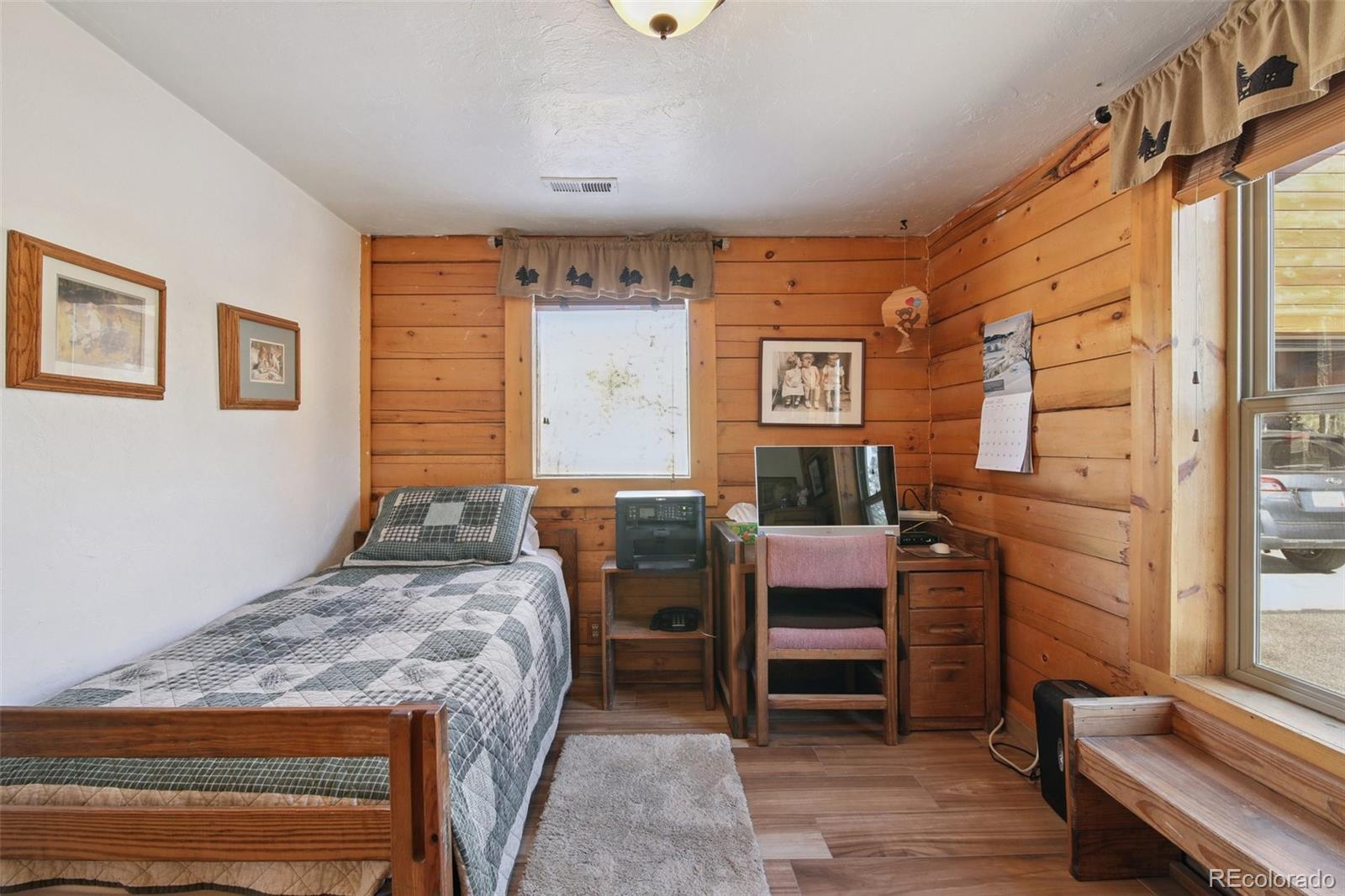 499 Clark Road Bailey, CO 80421 - Photo 13 of 27 a bedroom with a bed and a dresser