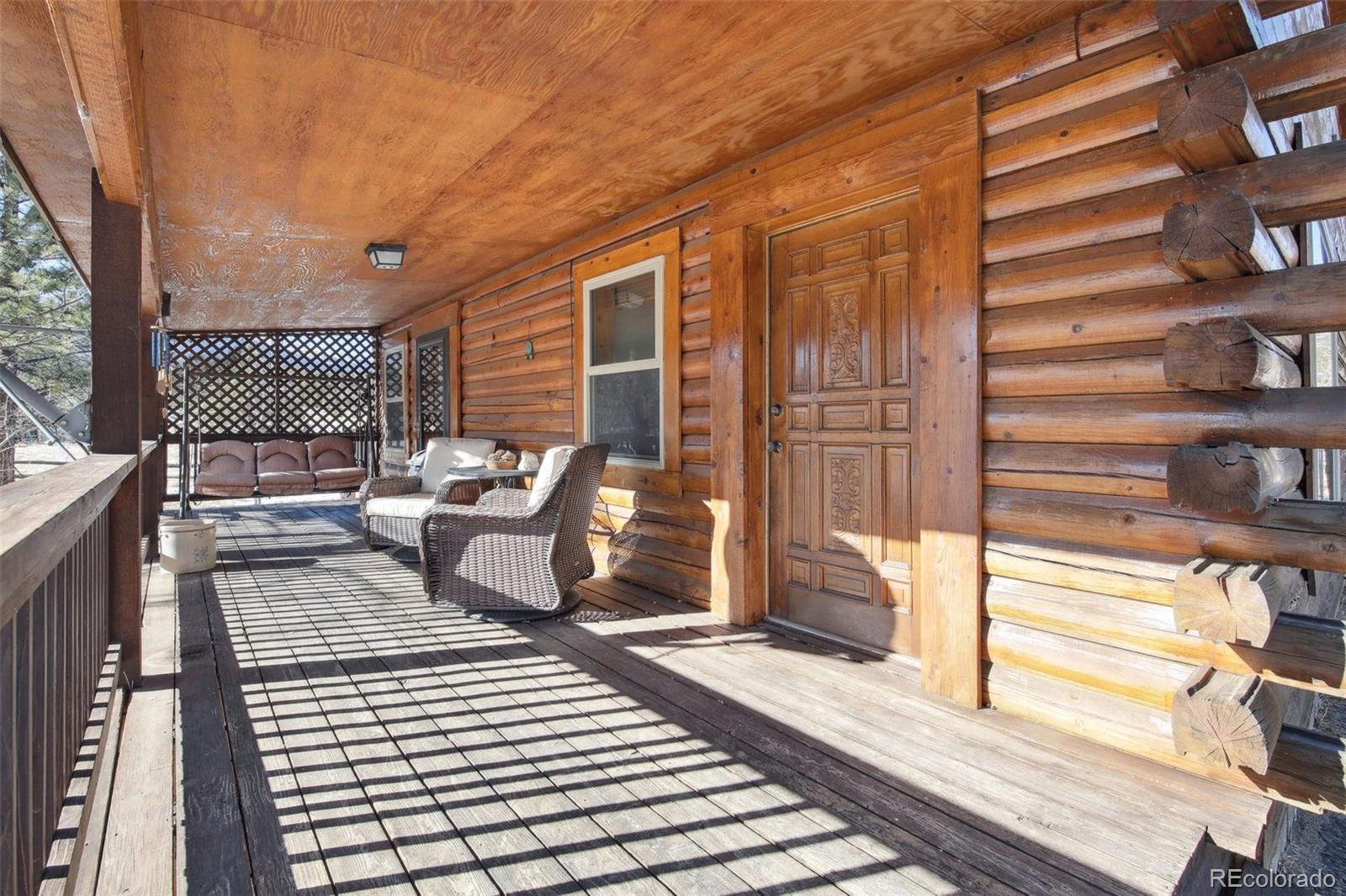 499 Clark Road Bailey, CO 80421 - Photo 17 of 27 a view of a chairs on the deck