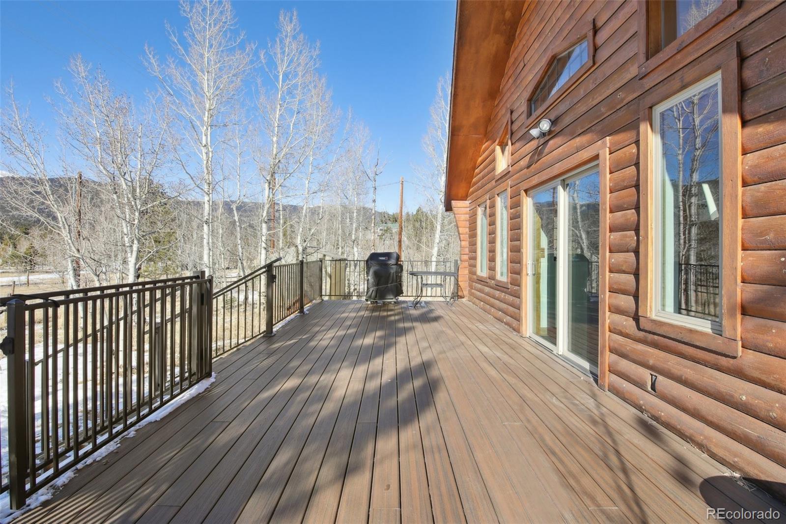 499 Clark Road Bailey, CO 80421 - Photo 18 of 27 a view of a balcony with wooden floor and fence