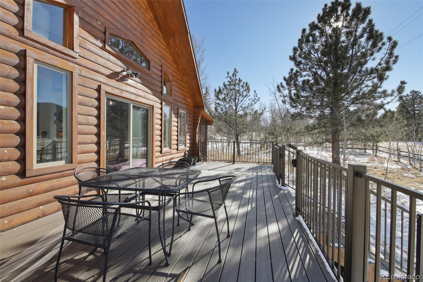 499 Clark Road Bailey, CO 80421 - Photo 19 of 27 a view of a wooden chairs and table in the balcony