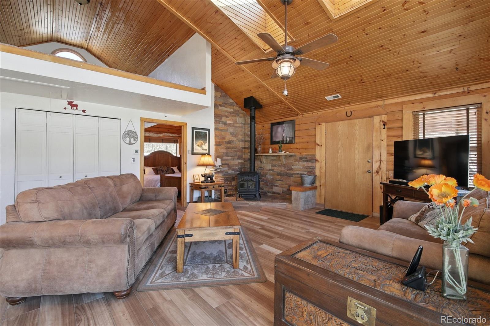 499 Clark Road Bailey, CO 80421 - Photo 4 of 27 a living room with furniture and a flat screen tv