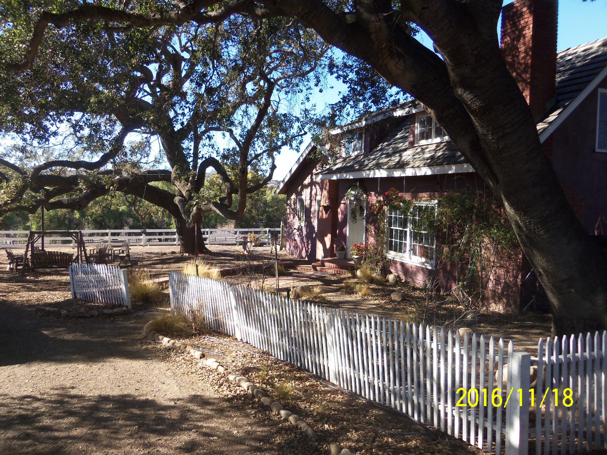 3050 Figueroa Mountain Road Los Olivos, CA 93441 - Photo 3 of 12 a view of a yard with wooden fence