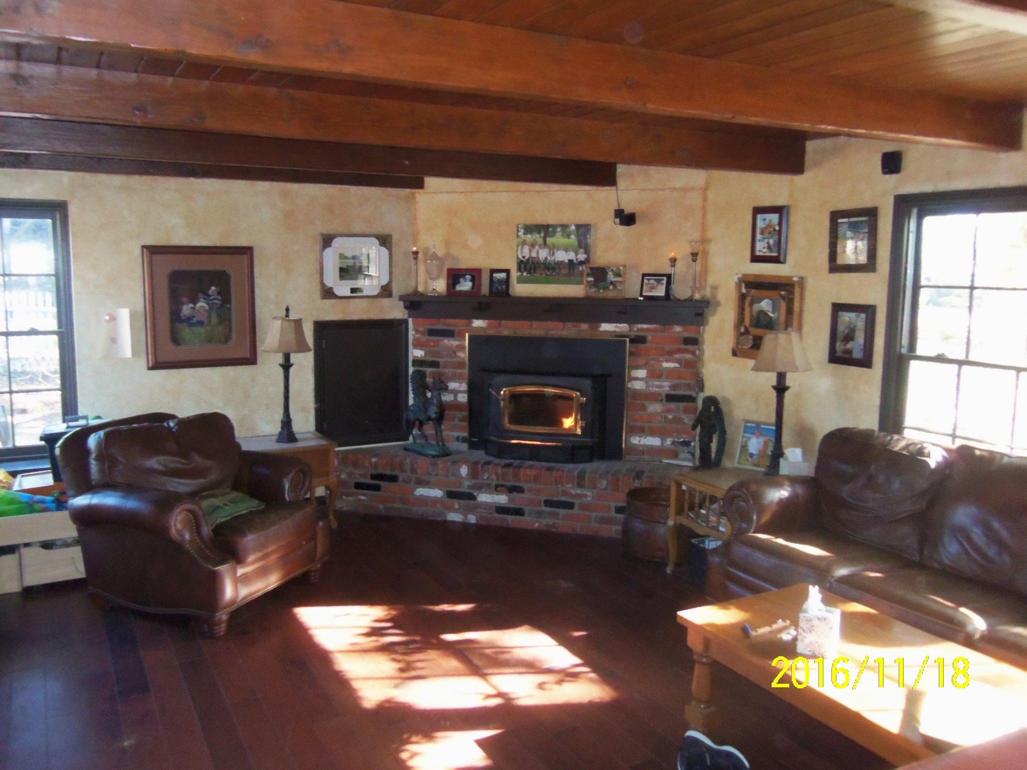 3050 Figueroa Mountain Road Los Olivos, CA 93441 - Photo 4 of 12 a living room with furniture a fireplace and a window